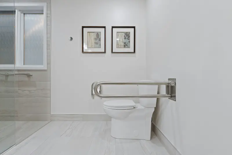Accessible bathroom with grab bar and non-slip flooring, designed for aging-in-place in Burlington