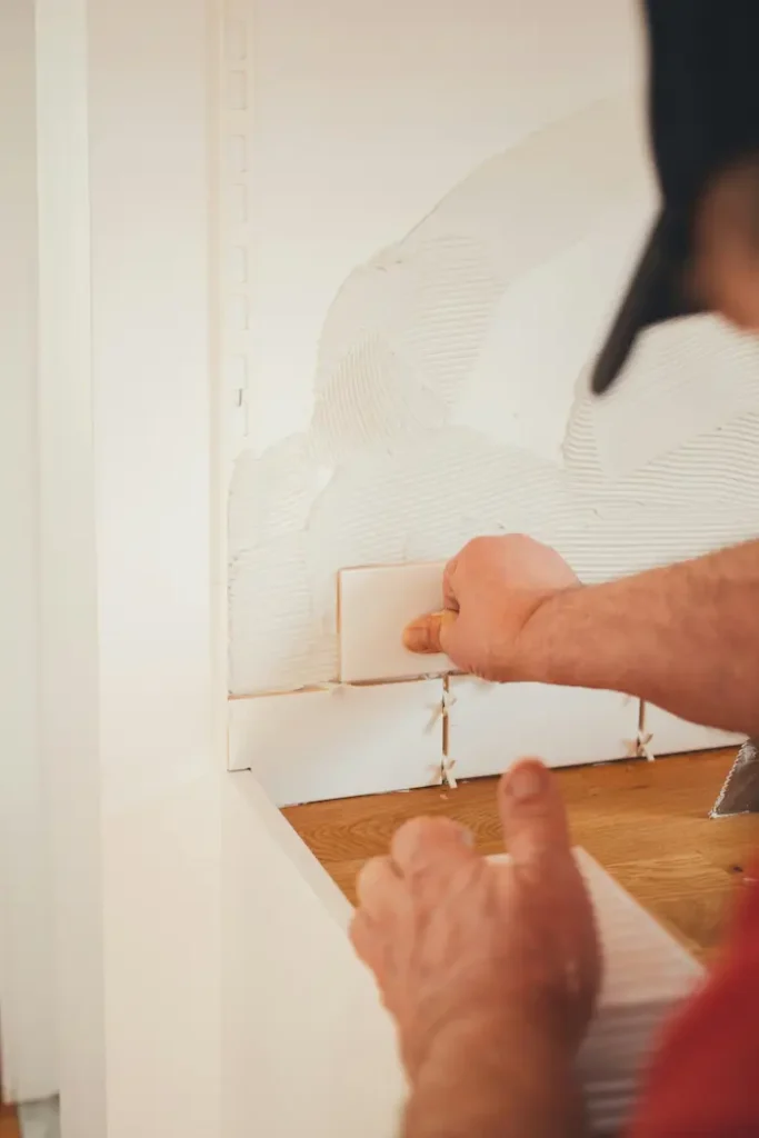 Precise tile installation with spacers during a bathroom renovation in Burlington