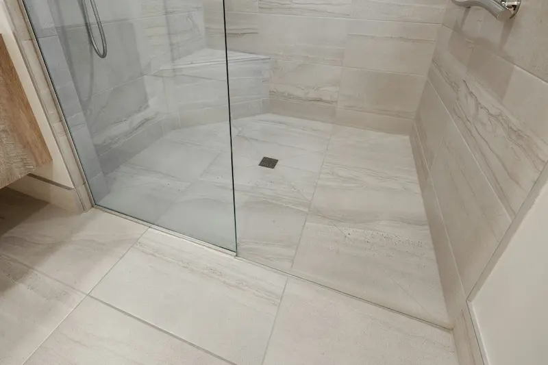 Waterproof tile flooring in a walk-in shower, part of a Burlington bathroom renovation