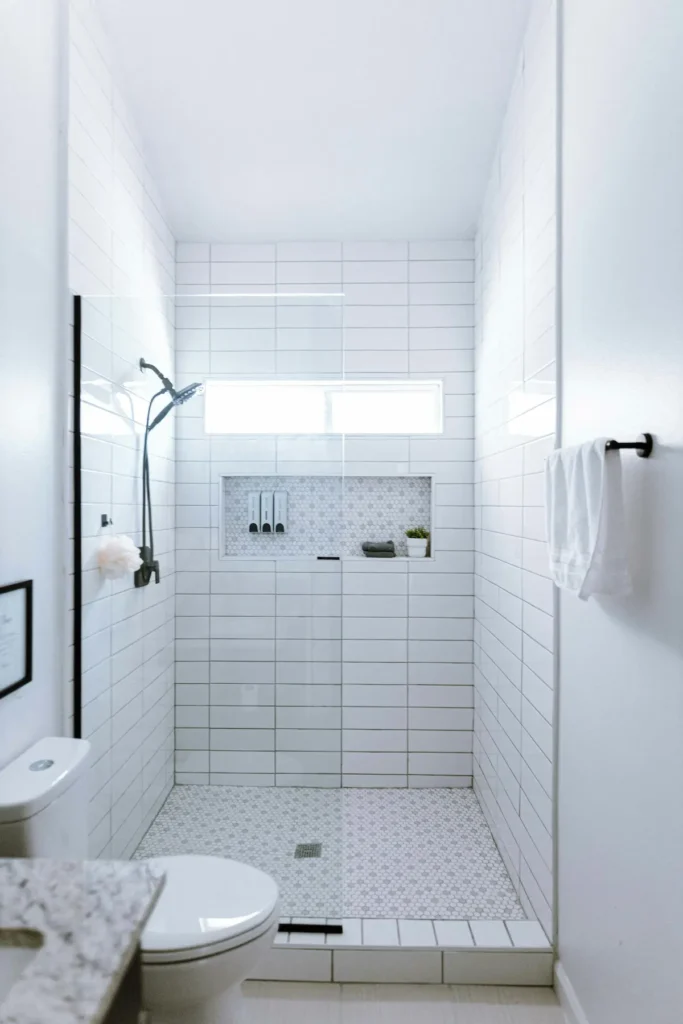 Walk-in glass shower with white subway tile in a Burlington bathroom renovation