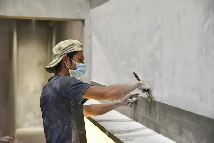 Professional wall finishing and plastering during a bathroom renovation in Burlington