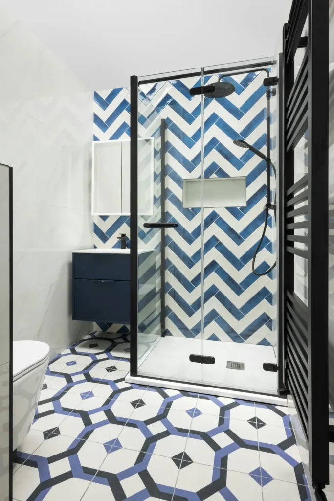 Blue chevron shower wall tile and geometric patterned floor tile in a Roseland, Burlington bathroom tile and flooring installation
