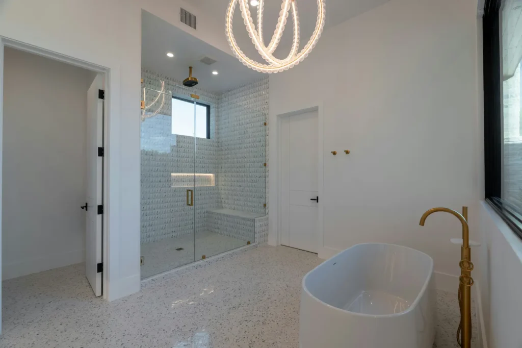 Bathtub to shower conversion cost example in Burlington with frameless glass walk-in shower and freestanding tub