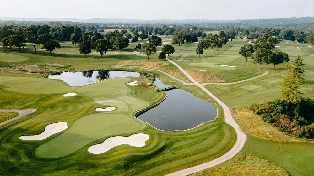 Aerial view of a manicured golf course with ponds and sand bunkers, representative of the golf-course community setting in Millcroft, Burlington