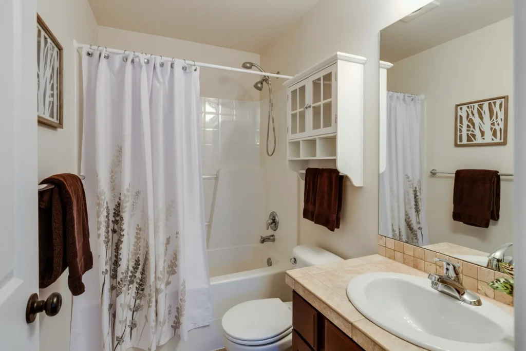 Outdated bathtub and shower curtain combo in Burlington home, a common candidate for tub replacement