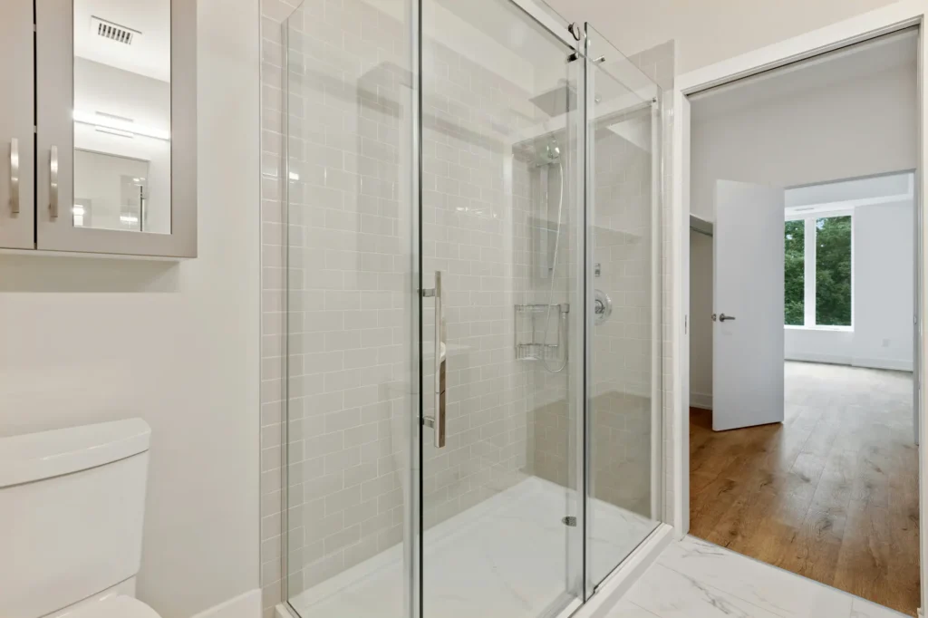 Shower conversion company in Burlington installing frameless glass enclosure with tile and Schluter Kerdi waterproofing