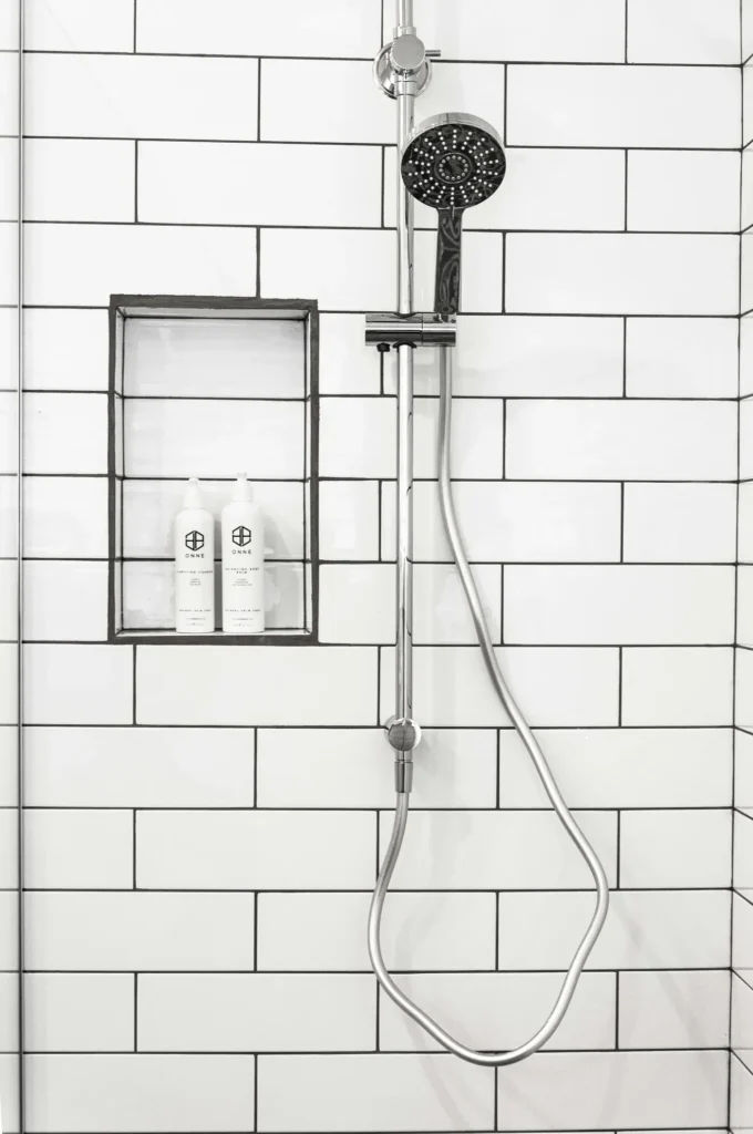 Shower fixtures and tile installation for a Burlington tub-to-shower conversion, including valve, showerhead, and plumbing rough-in