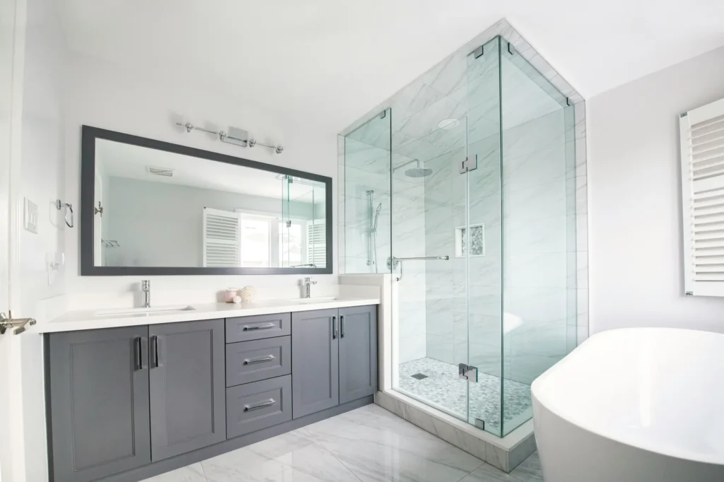 Finished tub to shower conversion in Burlington with modern glass shower and clean bathroom finish