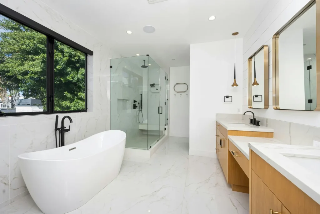 Walk-in bathtub to shower conversion in Burlington with frameless glass enclosure and curbless design